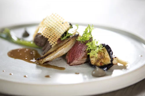A plate at Fou du Go&ucirc;t: grilled meat with shallot, aubergine and a crispy lace tuile