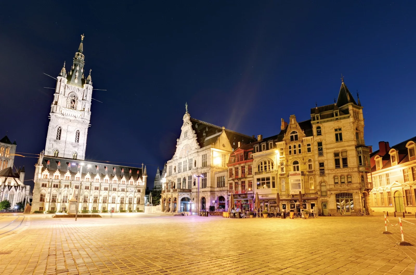 Sint-Baafsplein in Ghent at night, with the lit-up belfry and the fa&ccedil;ades around the square