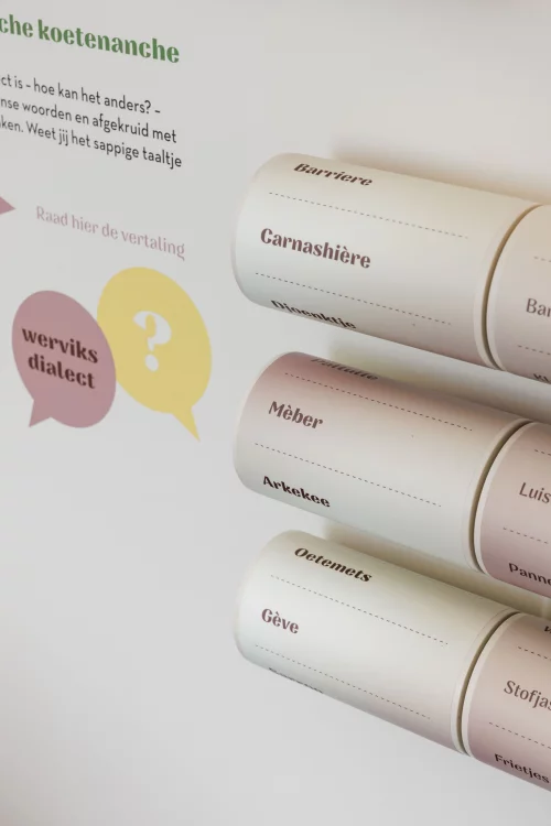 Een rij informatiepanelen op palen in het toeristisch onthaal van Wervik, voor een raam met de tekst Van Viroviacum tot Wervik